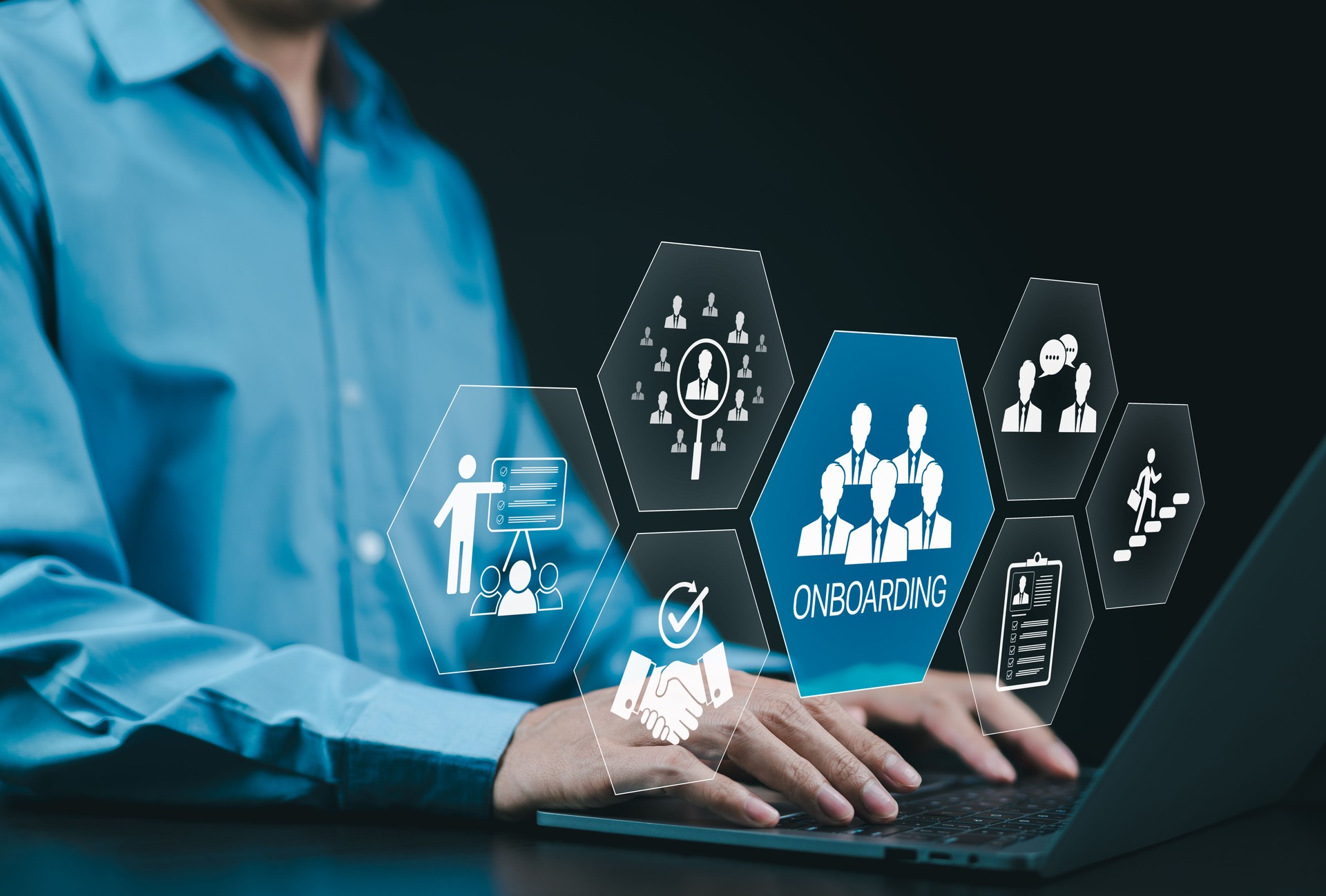 Onboarding new employee process concept. A businessman using laptop with icons representing onboarding process, training, recruitment, communication, hiring, development, and employee integration.